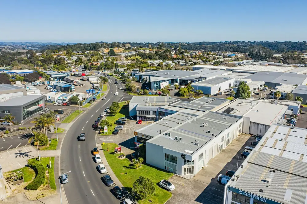 Aerial view of an Auckland commercial district with landscaped, well-kept building frontages along the street